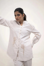 Load image into Gallery viewer, The model in white outfit, standing with one hand on her waist, looking slightly to the side with a calm expression.
