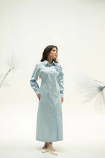 Load image into Gallery viewer, Front view of woman in blue corsage dress with long sleeves, minimal styling on white backdrop.