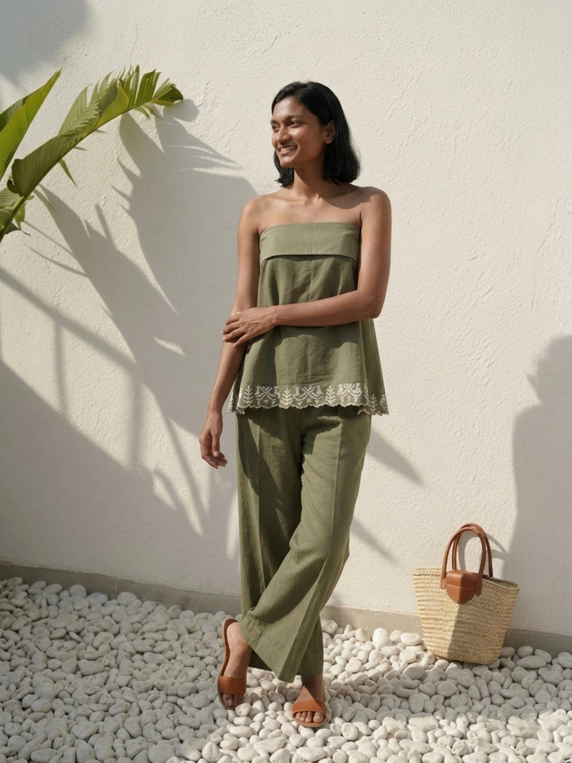 Model posing sideways in olive green strapless co-ord set – relaxed summer outfit with structured poplin top