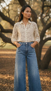 Woman styling ivory crochet summer lace shirt with blue jeans, full body view, casual white lace top for women.