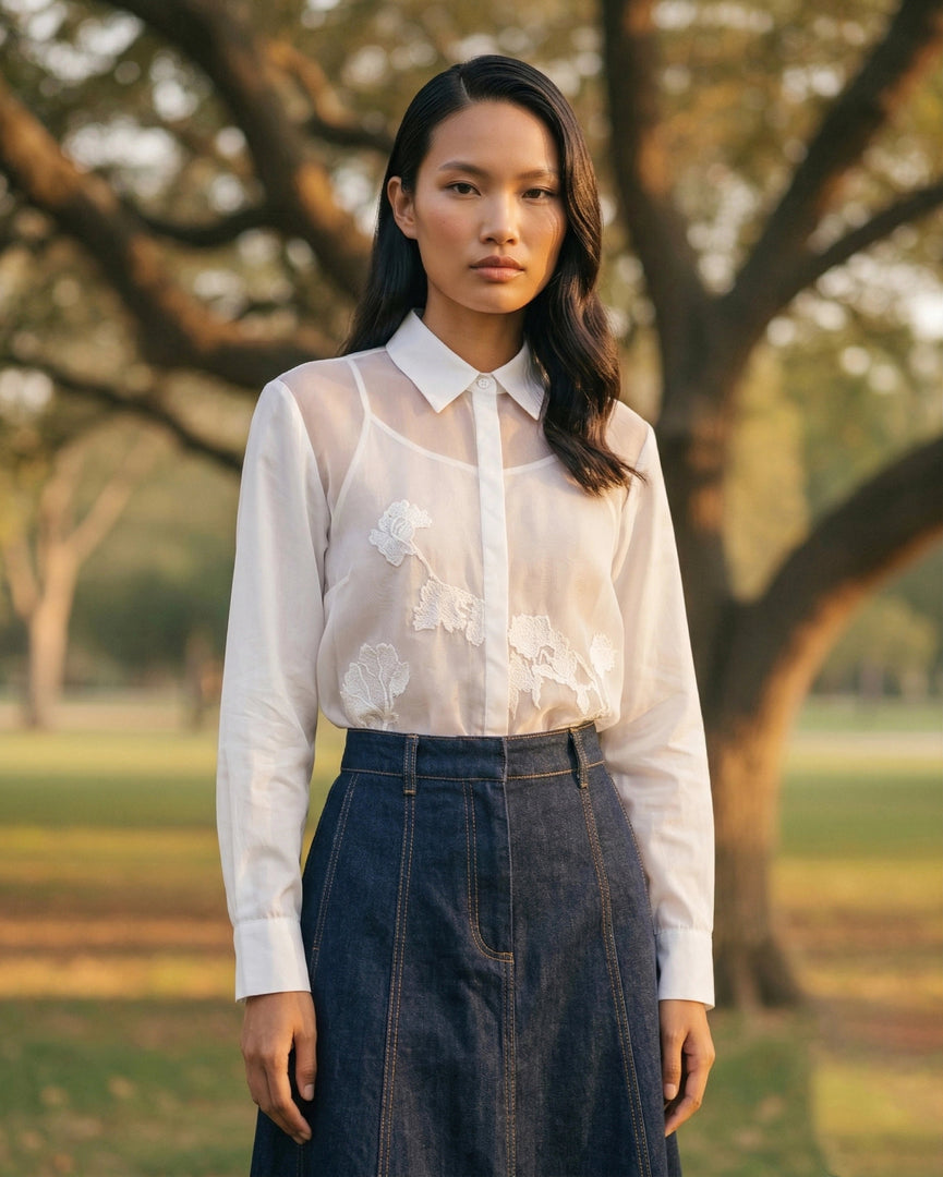 Classic white travel shirt styled with dark blue palazzo pants, chic everyday women’s wear.