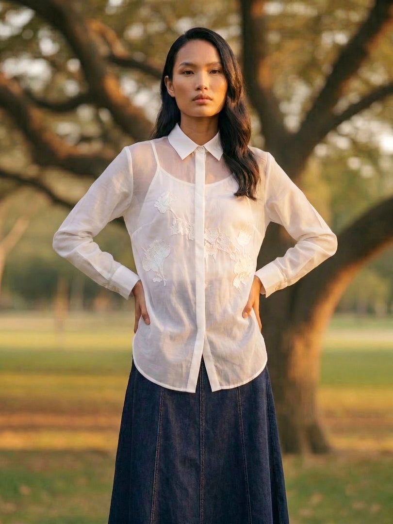 Elegant white women’s shirt with navy bottoms, timeless summer travel and smart casual fashion style.